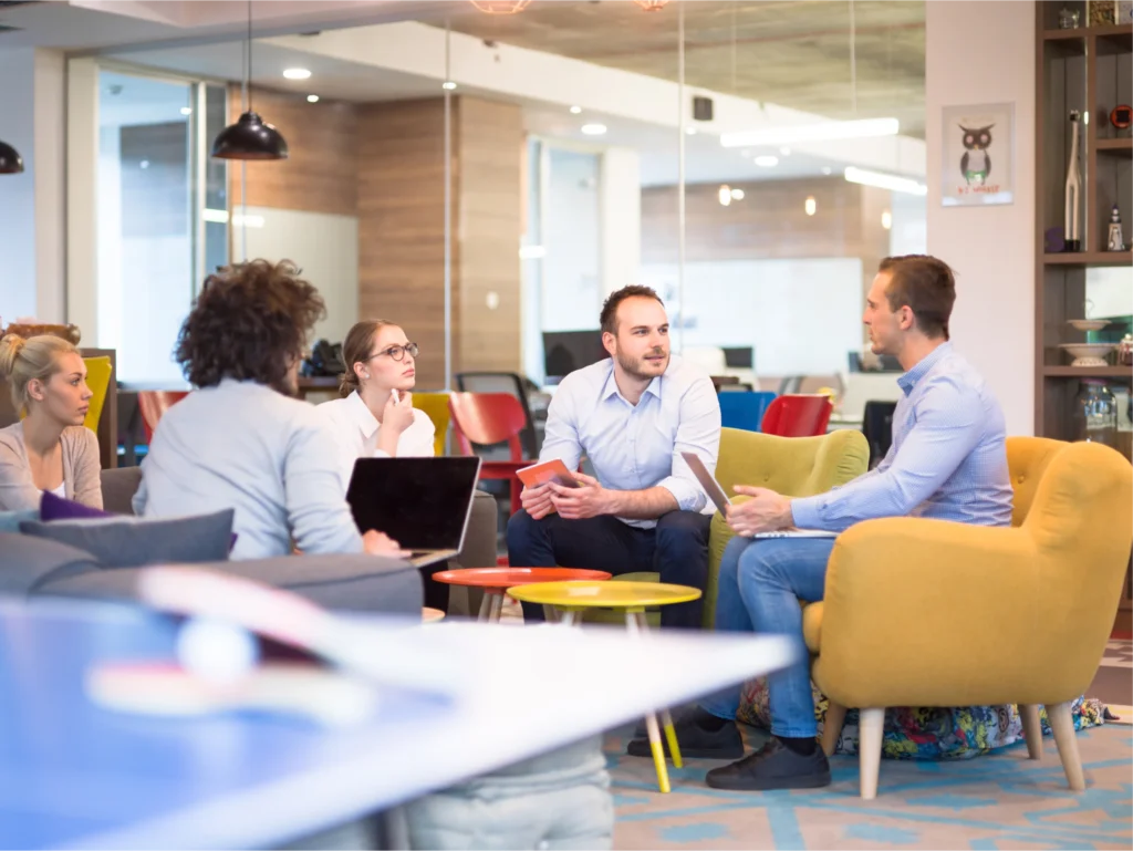 people at work sitting around a lounge